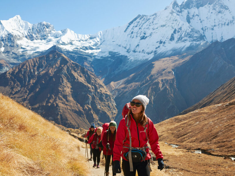 a group of travellers traversing Annapurna Base Camp with Intrepid Travel