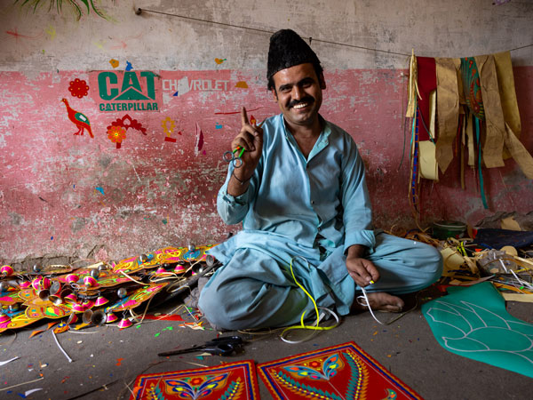 a worker making truck decor, Taxila