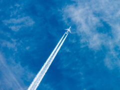 passenger plane leaving slip stream through the air, farting on a plane​