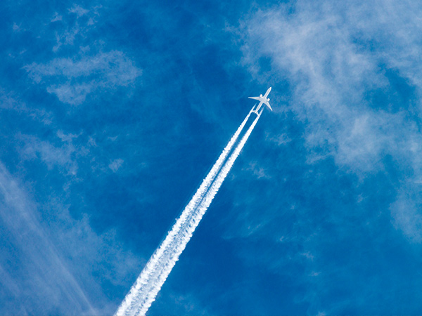 passenger plane leaving slip stream through the air