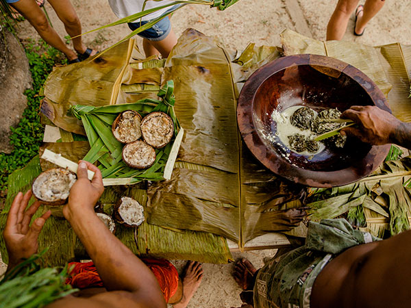aerial of food cooked in an umu being served to guests in samoa