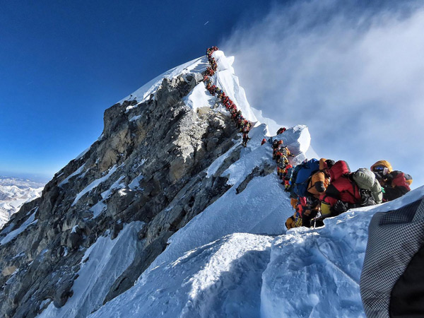 People queuing to reach Mount Everest Summit/Top of the World / Highest Mountain in the Himalayas Nepal