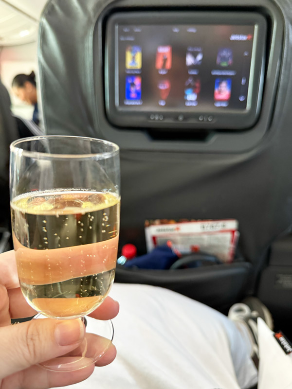 a glass of sparkling wine onboard Jetstar’s Boeing 787 Dreamliner Business Class