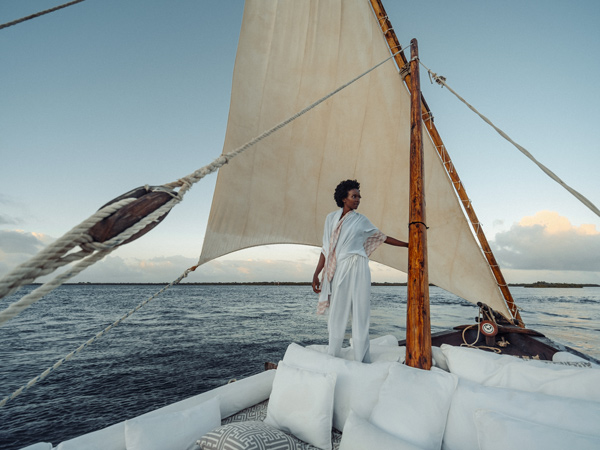 a woman standing on the edge of the boat in Kenya