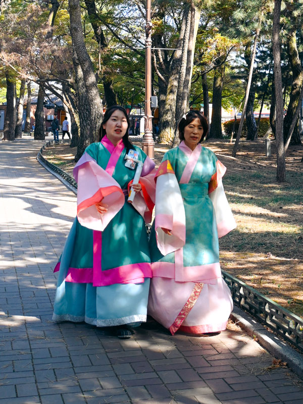 visitors dressed up in traditional hanbok at Daereungwon Tomb Complex, South Korea