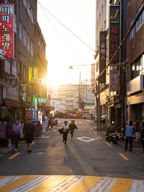 two people running on the streets of Seoul
