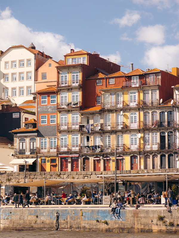 People drinking besides The Douro River.