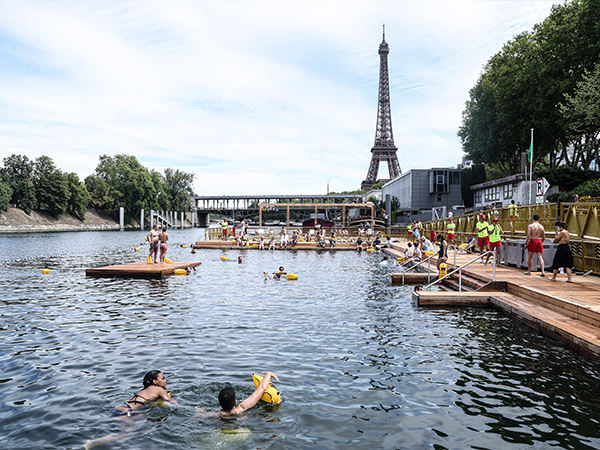 People swimming in the River Seine with a view of the Eiffel Tower