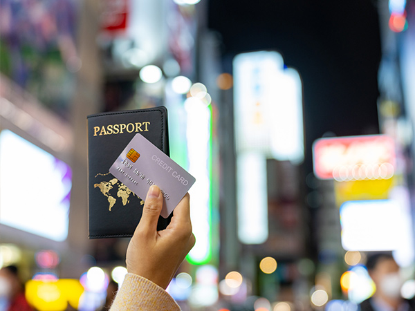 woman showing passport and credit card during shopping at Shibuya district, Tokyo city, Japan