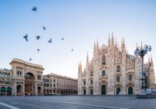Galleeria Vittorio Emenuele and Milan Cathedral square with flying pegion in the morning