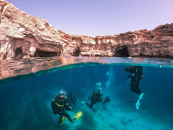 Scuba divers exploring and enjoying sea life in malta