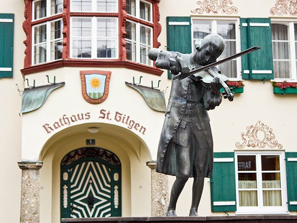 Statue of young Wolfgang Amadeus Mozart in front of townhall on Mozartplatz in St. Gilgen, Austria