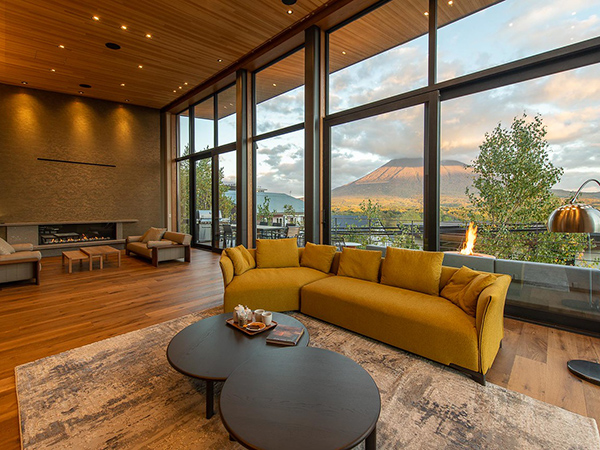 A sprawling living room framed by breathtaking mountain views.