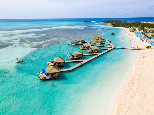 Overwater bungalows off a beach in the Caribbean