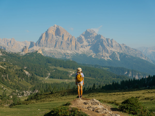 a woman hiking in Dolomites mountains