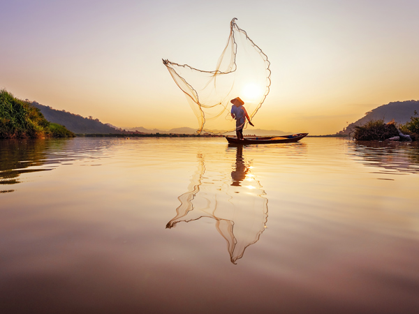 a fisherman casting net at Mekong River