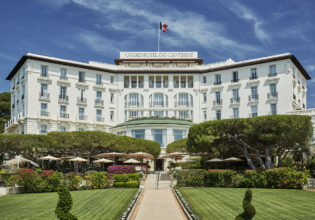 The grand white exterior of the Grand-Hotel du Cap-Ferrat, A Four Seasons Hotel