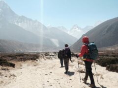 group tour hiking towards himalayan mountain ranges