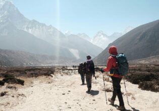 group tour hiking towards himalayan mountain ranges