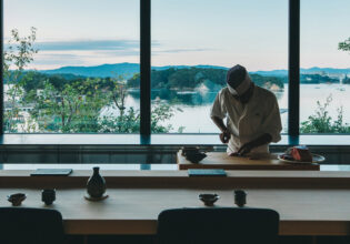A chef prepares sushi with the mountains and sea as a backdrop — a moment to get beautifully lost in Japan’s flavours and scenery.