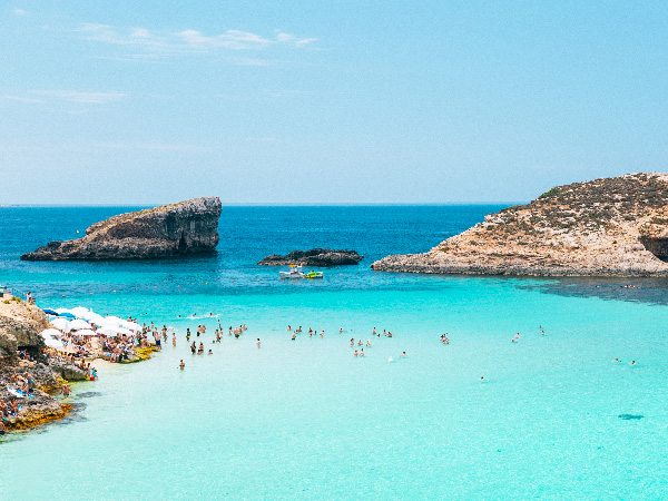 The Blue Lagoon - Beach with crystal clear water and rock formations on Comino island, Malta