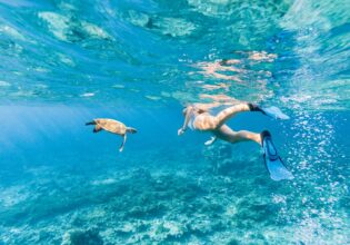 Woman explores the reef around the atoll in the Maldives