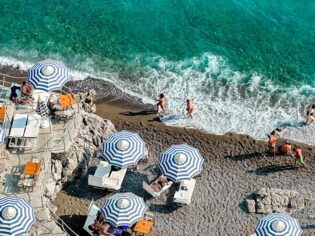 People enjoying the sun and ocean in Positano in Italy