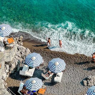 People enjoying the sun and ocean in Positano in Italy