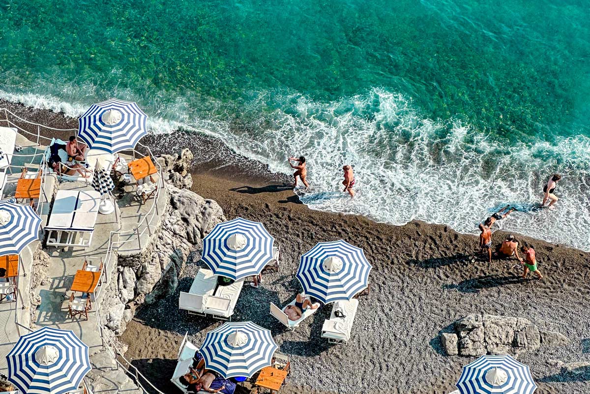 People enjoying the sun and ocean in Positano in Italy