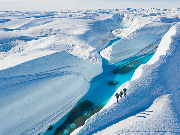 guest of white desert exploring blue ice frozen lake