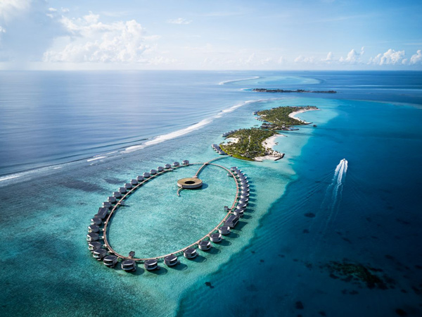 an aerial view of The Ritz-Carlton Maldives with luxurious cabanas in the tranquil blue ocean