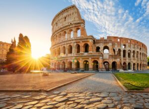 in front of the the Colloseum in rome at sunset