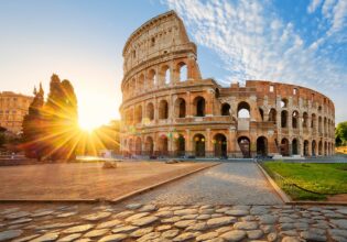 in front of the the Colloseum in rome at sunset