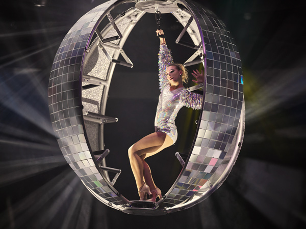 A performer inside a large disco ball on Celebrity Xcel