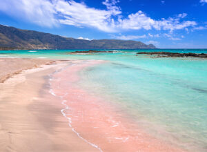 The pink sand at and turquoise water at Elafonissi Beach, Crete, Greece.