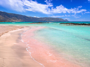 The pink sand at and turquoise water at Elafonissi Beach, Crete, Greece.