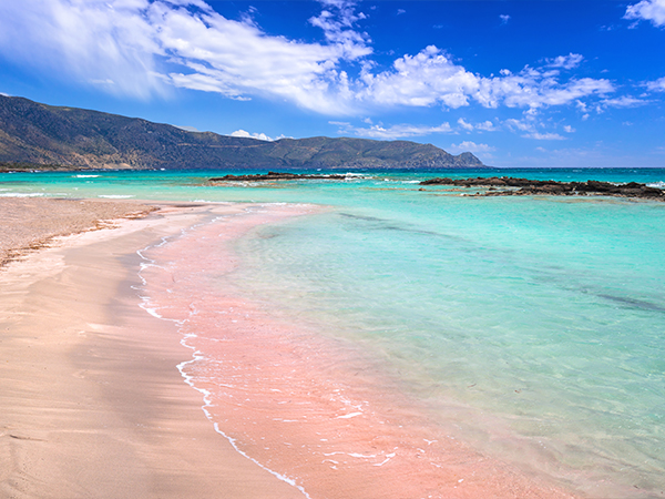 The pink sand at and turquoise water at Elafonissi Beach, Crete, Greece.
