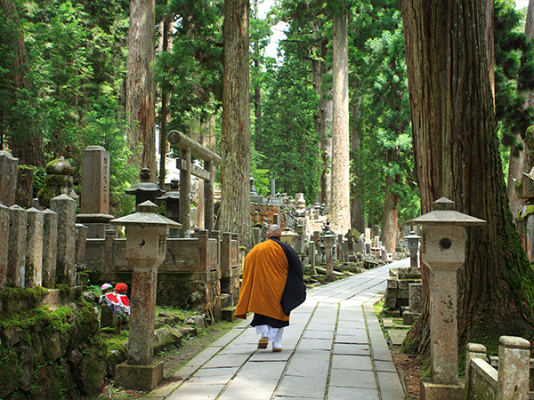A monk walking in a graveyard in Mount Koya