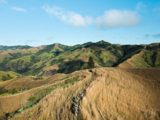 Hiking group through Fiji Highlands via a drone