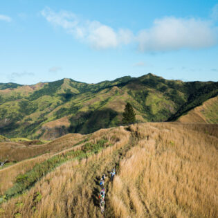 Hiking group through Fiji Highlands via a drone