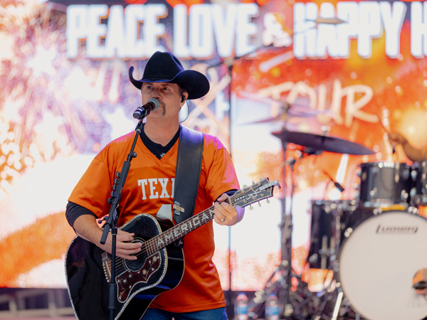 a country musician performing at the UFCU tailgating party