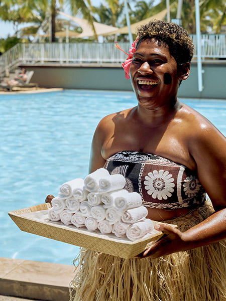 staff memeber by the pool at Fiji Marriott Resort Momi Bay
