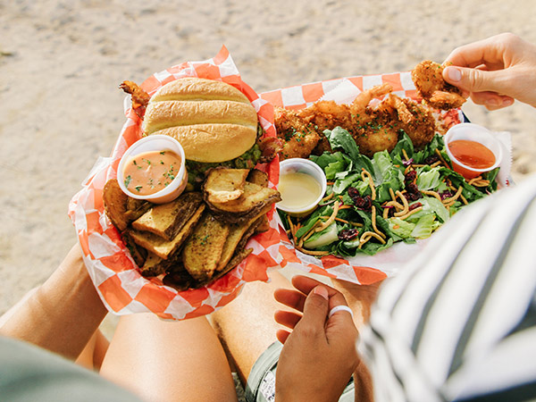 couple eating Seven Brothers on the beach in o'ahu