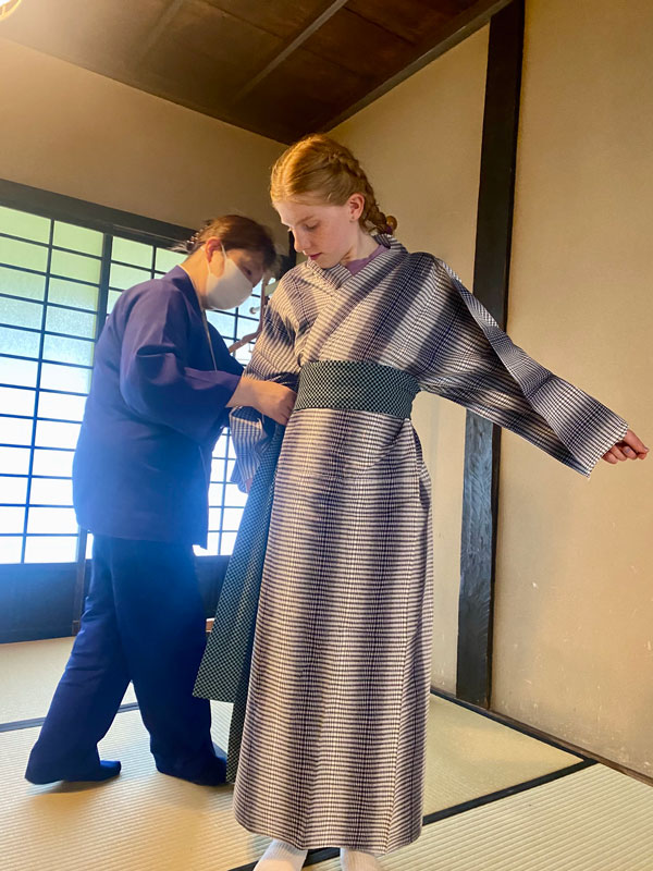 the writer's daughter being fitted with a yukata