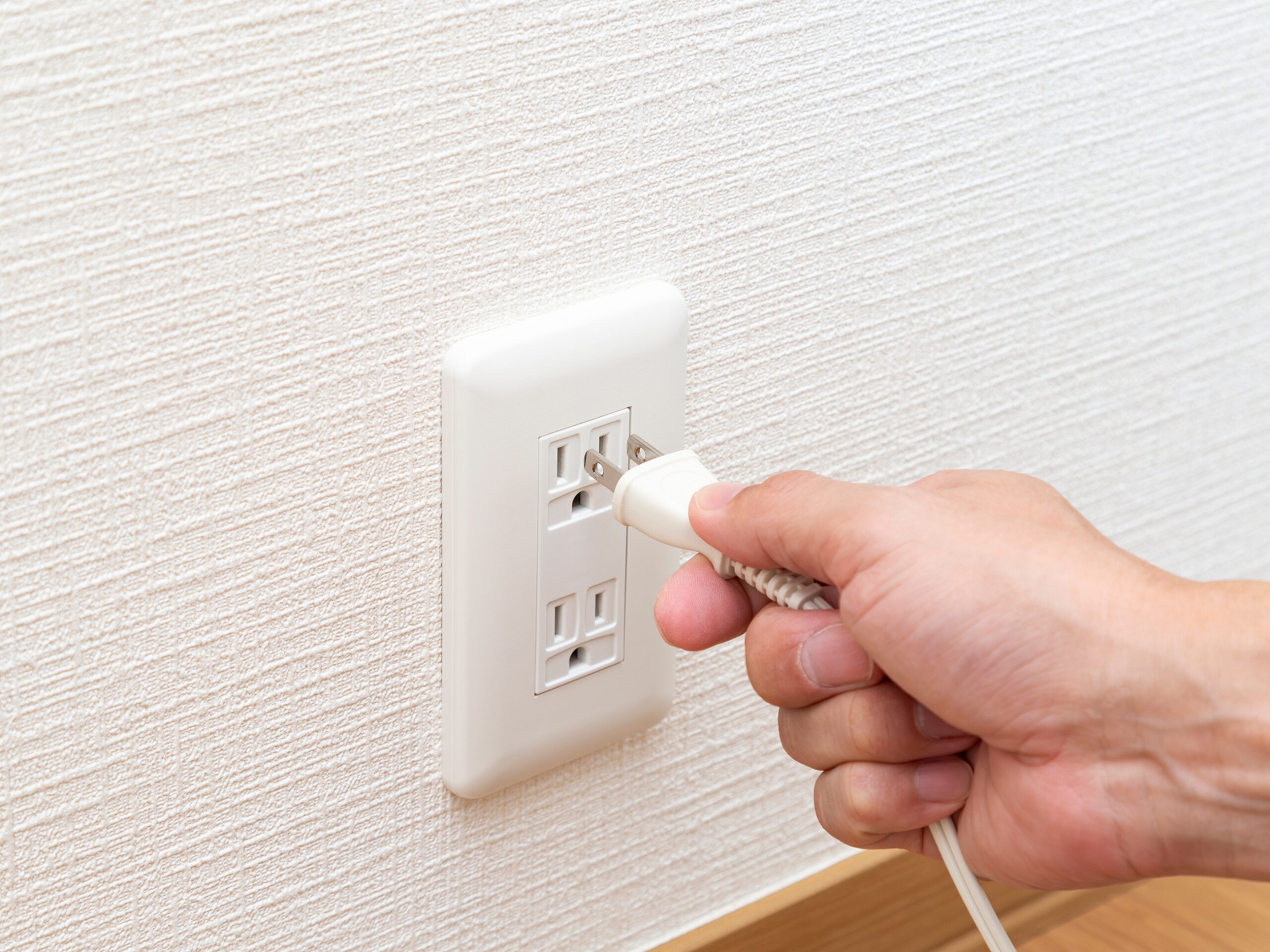 hand inserting a power plug