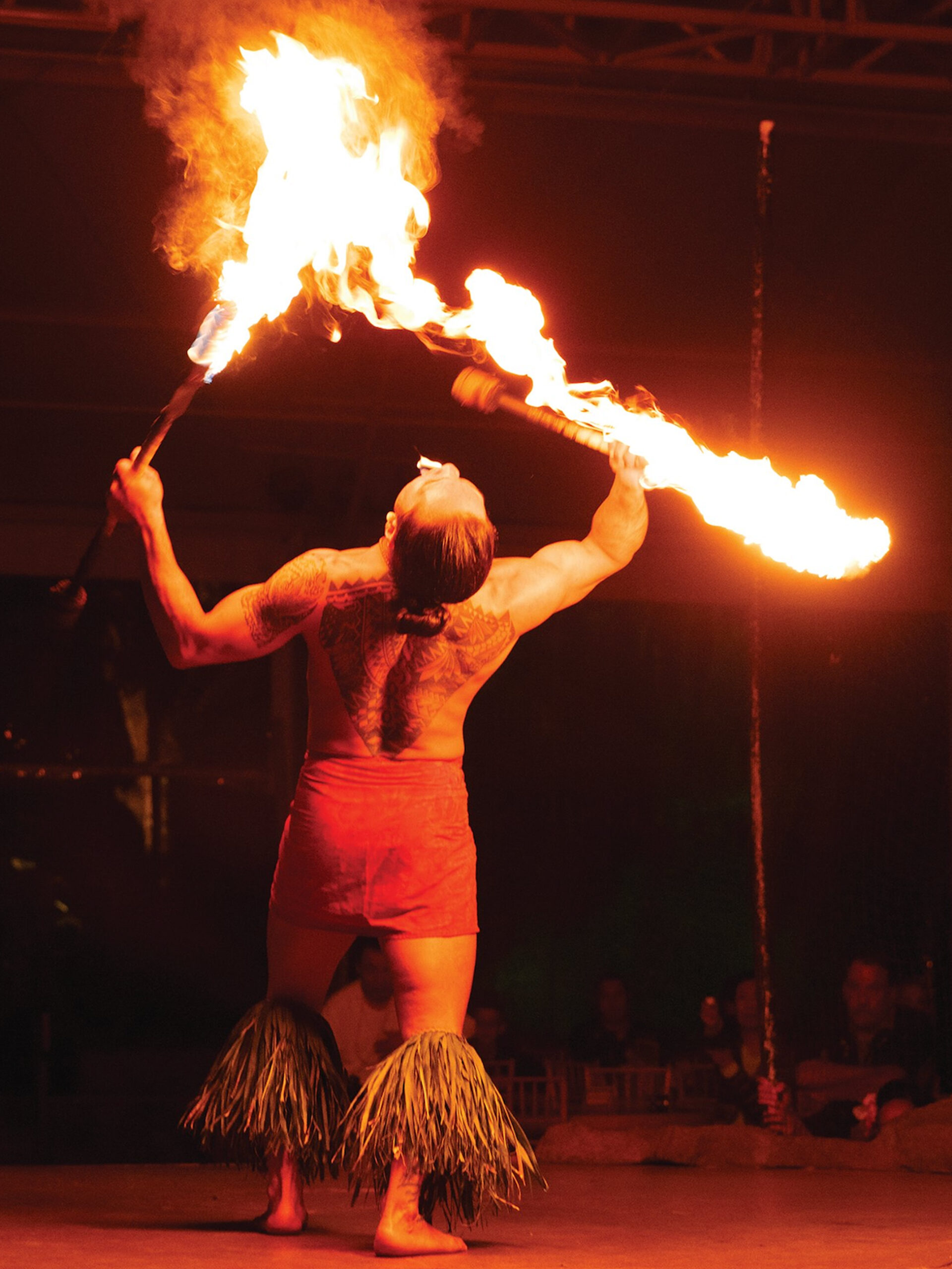 fire dancing at Lū&lsquo;au Kalamaku