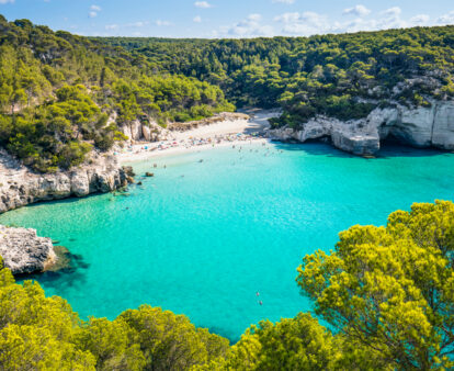 Cala Mitjana beach in Menorca .