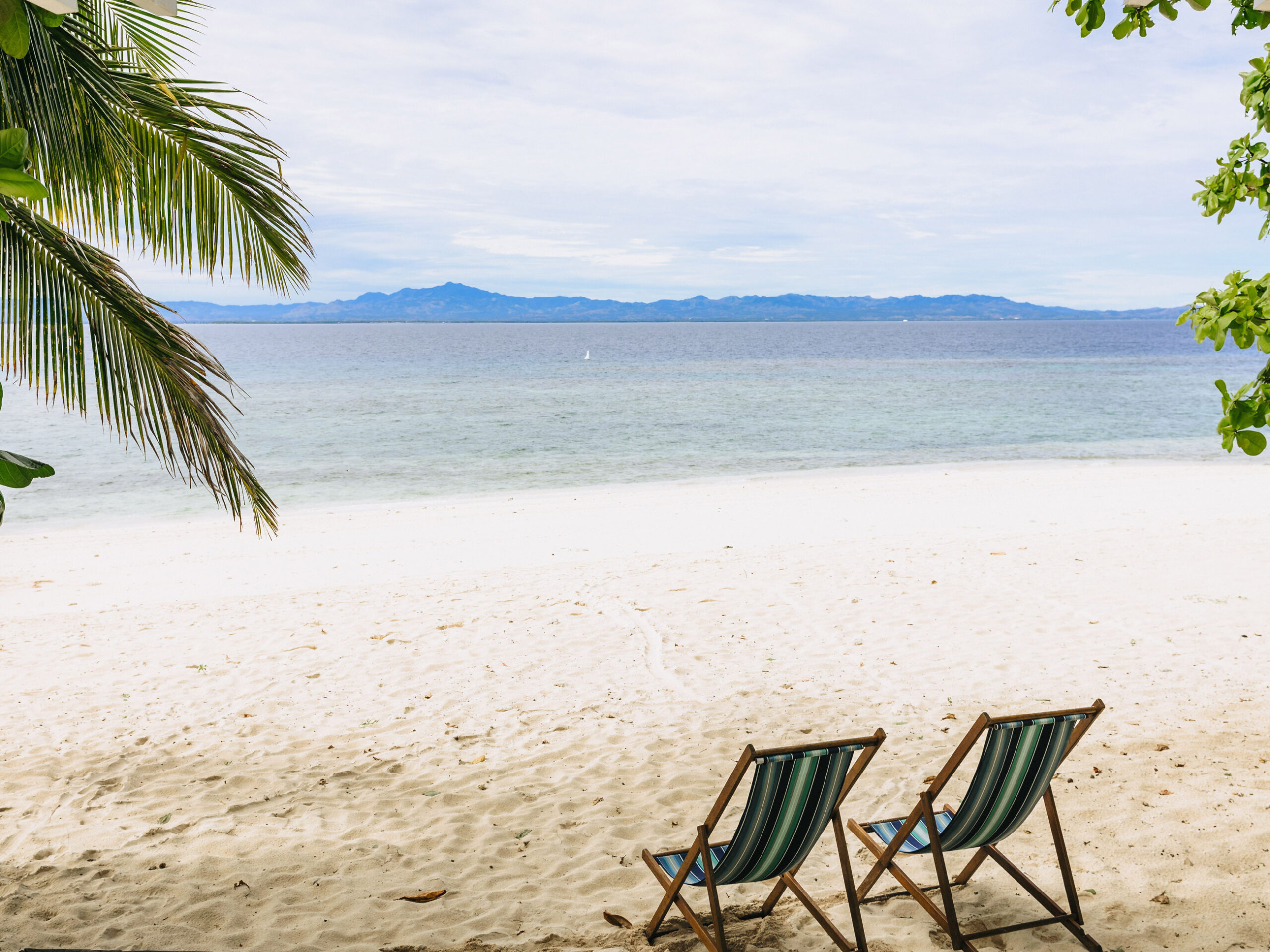 a white-sand beach with sun loungers at Malamala Beach Club, Fiji