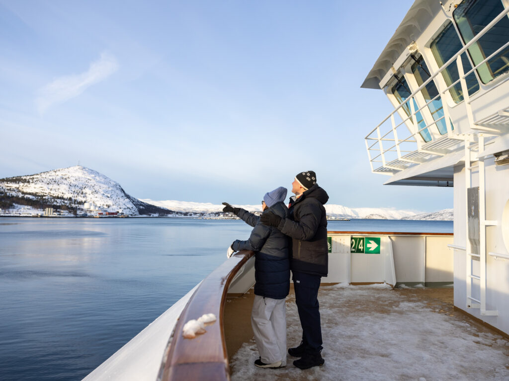 Couple looking out at view onboard Hurtigruten