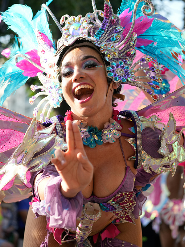 A Colombian dancer greets you mid-step.